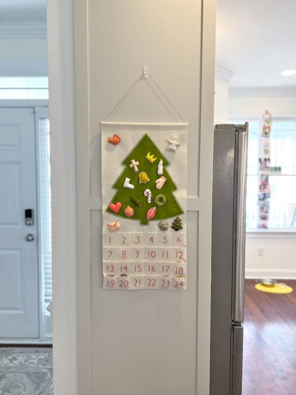 Colorful felt Advent calendar from Purl Soho hanging on the wall