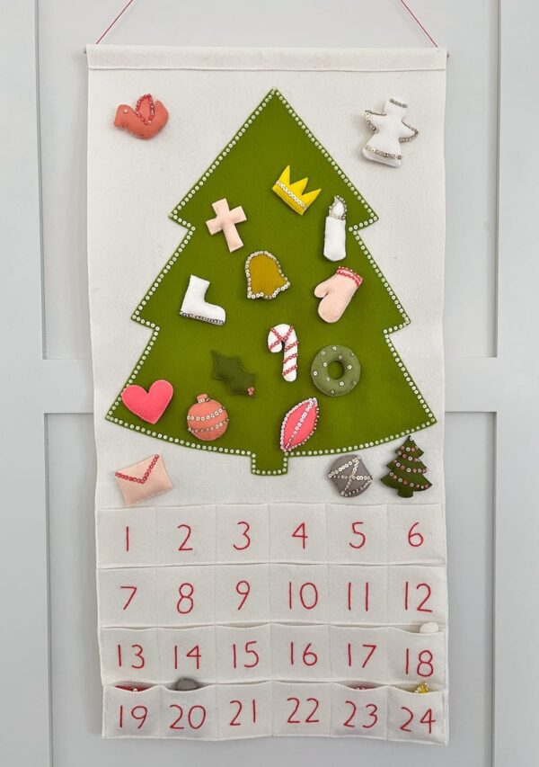 Colorful felt Advent calendar hanging on the wall from Purl Soho