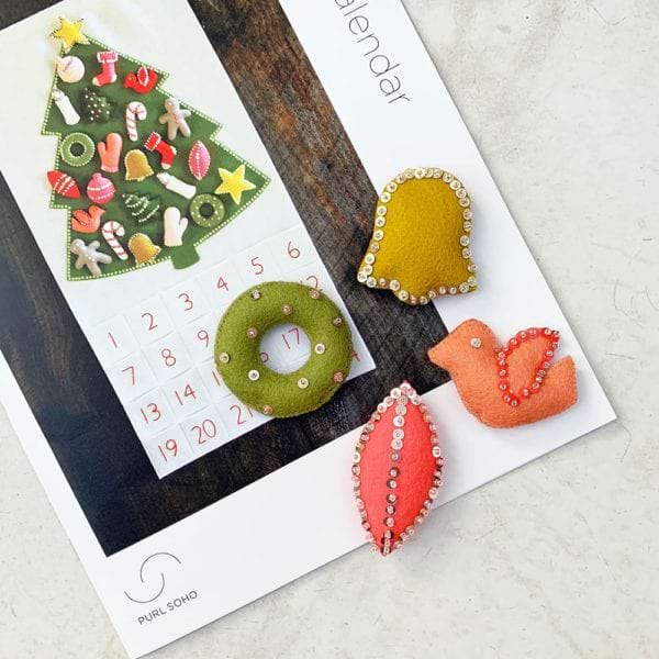 Purl Soho Advent calendar with bell, wreath, and dove ornaments