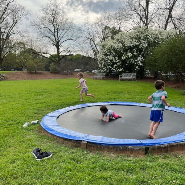 Serenbe in-ground trampoline with kids bouncing